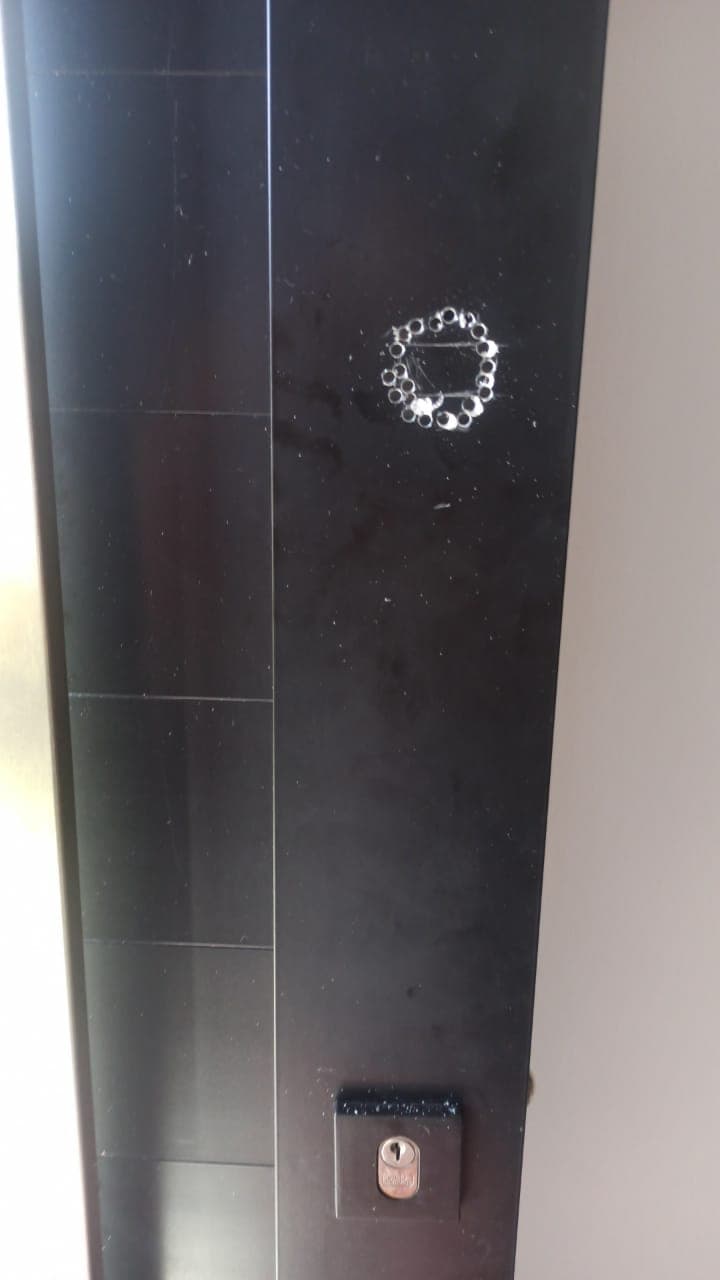 Porta preta de entrada com o cilindro da fechadura embaixo, foto de um atendimento do Sergio